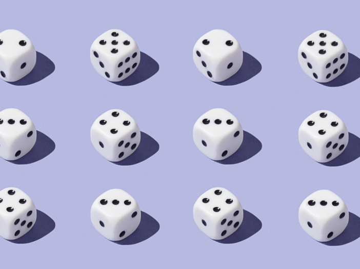 Twelve dice sitting on a light purple background in three rows of four.