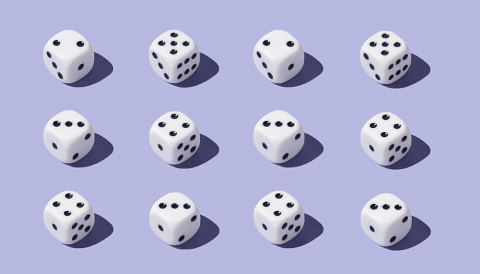 Twelve dice sitting on a light purple background in three rows of four.